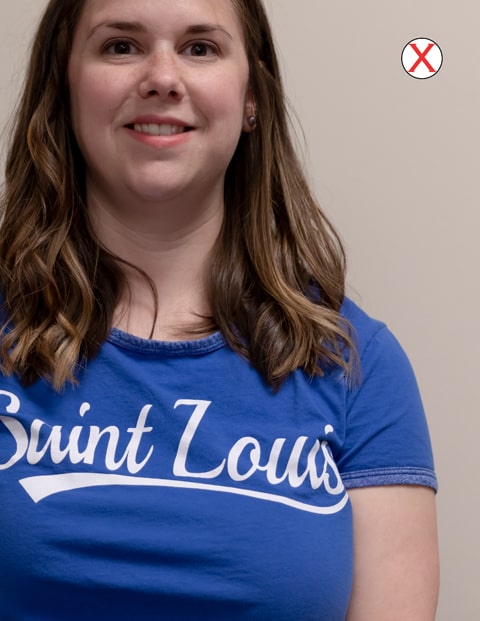 Example of bad crop A headshot of a woman wearing a SLU t-shirt. The photo is poorly cropped, cutting off the top of her head and her entire left side.
