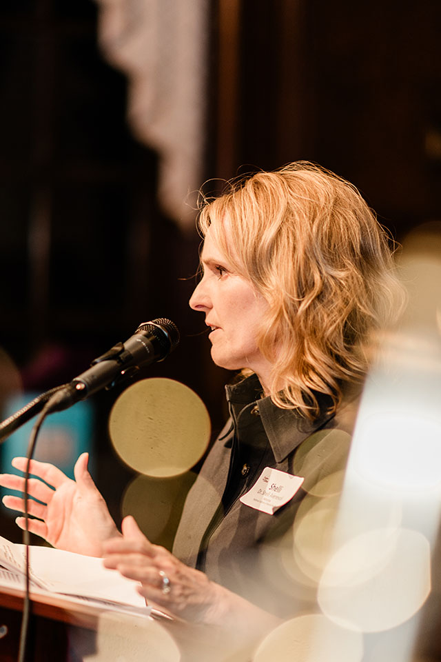 Shelli Avenevoli speaks at a lectern