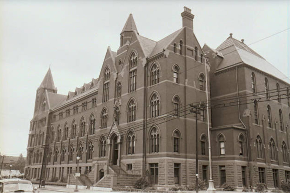 DuBourg Hall An old photo of a large brick building on campus.