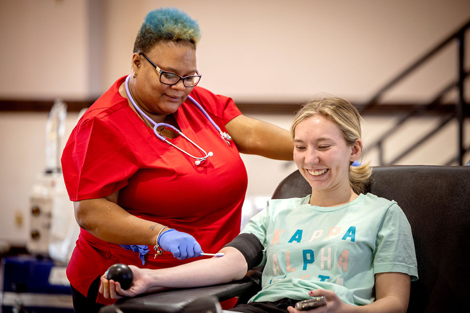 CSA Blood Drive 2023 A student squeezes a stress ball while preparing to have her blood drawn during a blood drive hosted by the Center for Social Action.