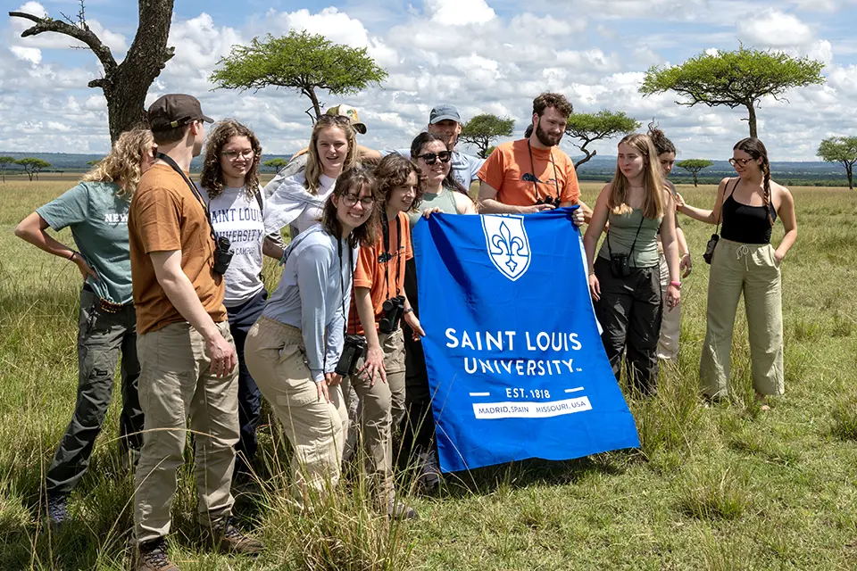 Landscape with a group of students in a grassy savanna.