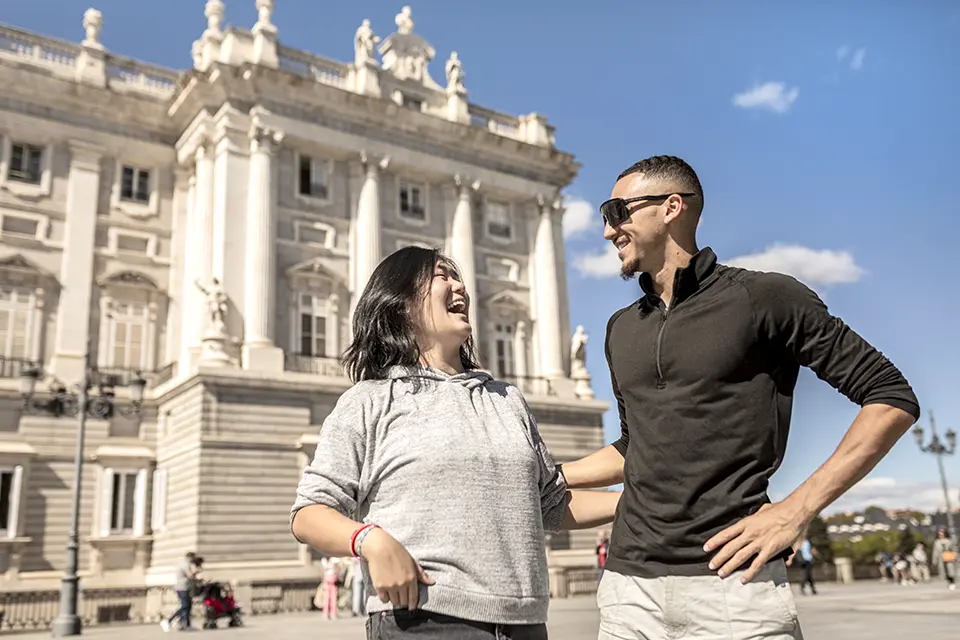 Legal status while in Madrid Two students laughing and strolling near the Royal Palace in Madrid.