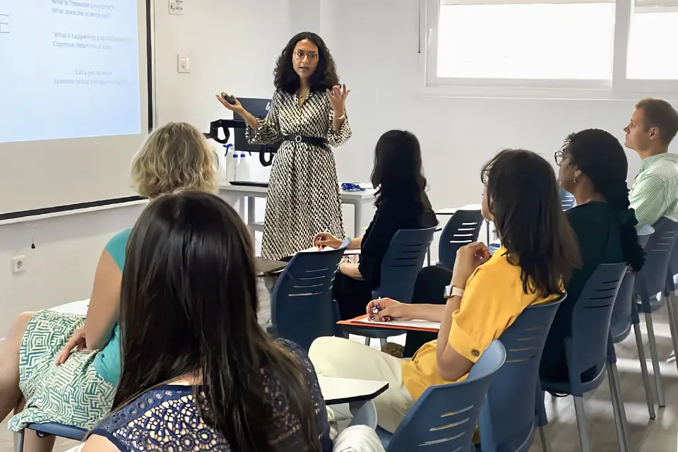 Counseling workshop Students sit at desks while a leader discusses a topic.