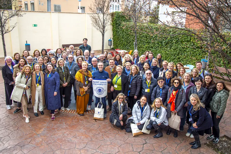 Attendees pose in the Padre Rubio Hall patio