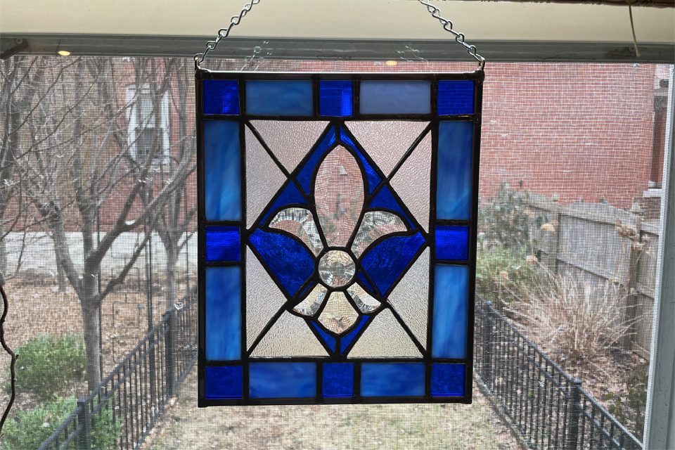 A picture of a blue stained glass piece made by faculty member A picture of a blue stained glass piece made by faculty member