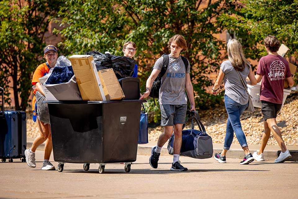 New students push their belongings across the street with help from SLU Oriflamme members during Move-in.