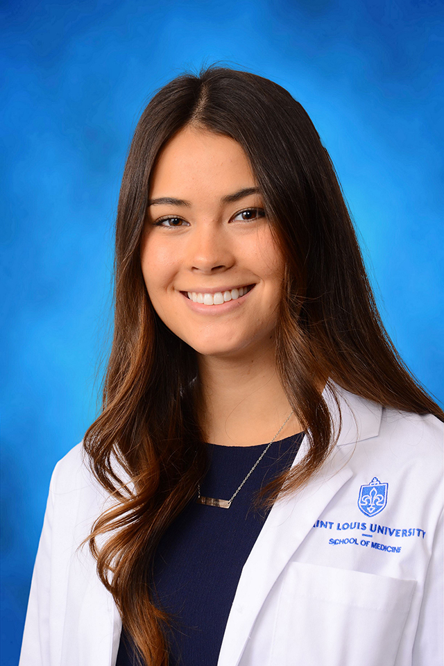 Megan Halloran poses for a headshot against a blue background.