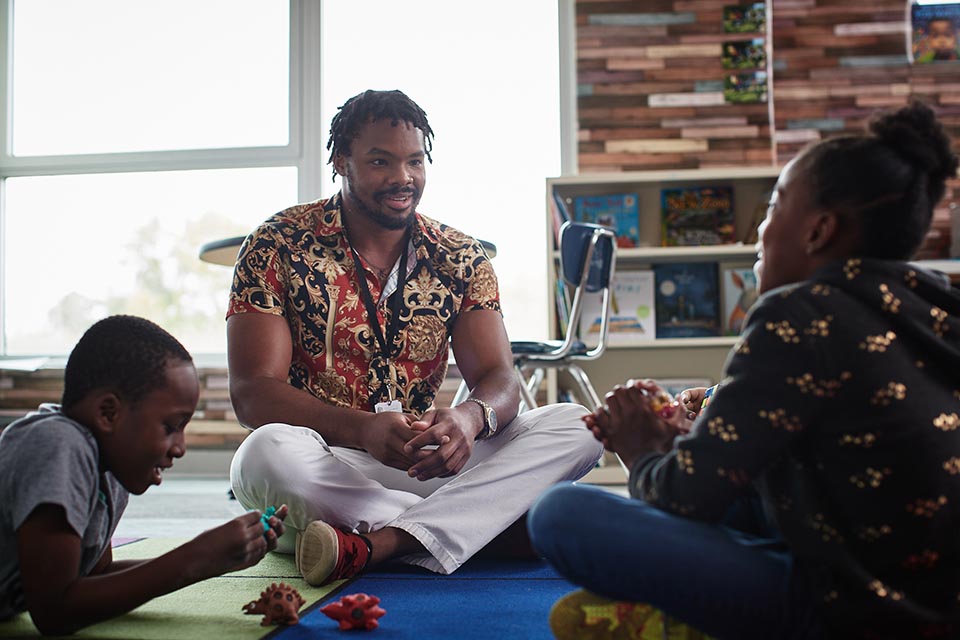 Applied Behavior Analysis Man sitting on floor with children