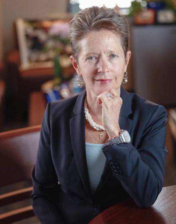 Daniela Salvemini, Ph.D., sitting at a wood desk. Daniela Salvemini, Ph.D.