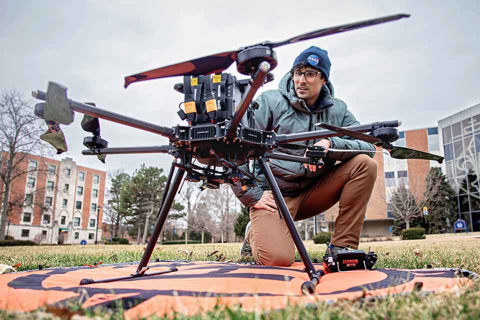 Big Ideas A man examines a large drone on SLU's campus