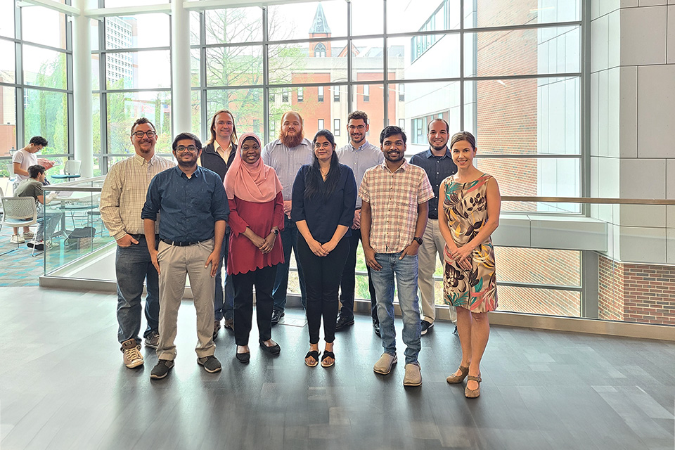 The Open Source with SLU team poses for a photo while standing in two row.