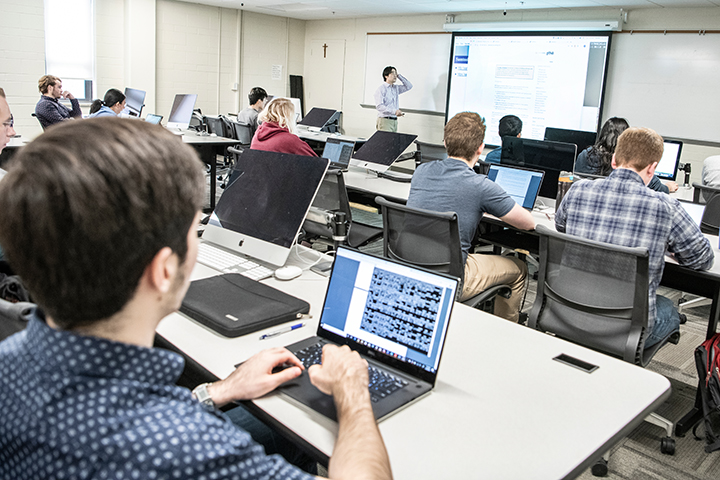 computer science class Students with laptops in computer science classroom