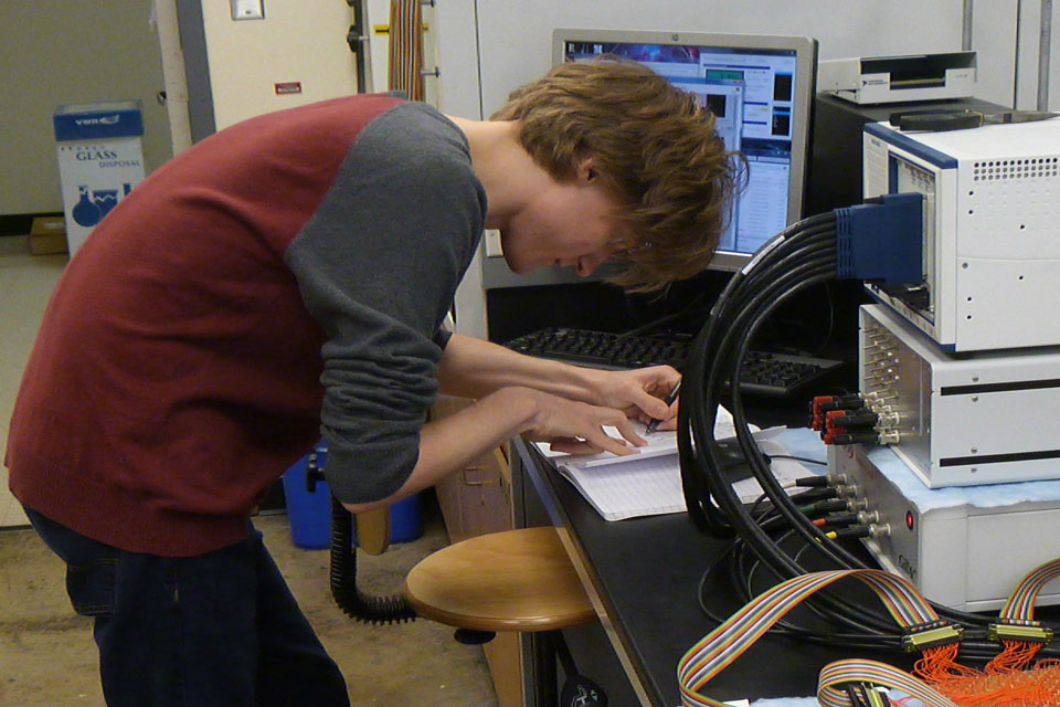 Student writing notes at computer Student writing notes at computer