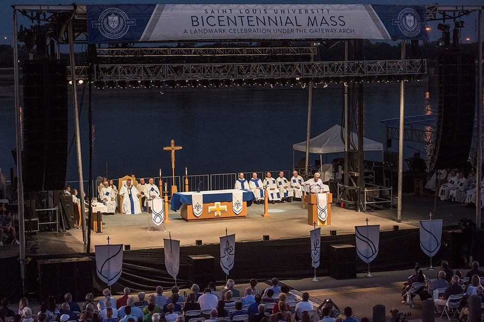Pestello addresses a crowd following the Bicentennial Mass held under the Gateway Arch. Pestello on stage, at a podium, addresses a crowd of 6,000 following the Bicentennial Mass under the Gateway Arch.