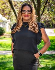 Knieba Jones Johnson Knieba Jones Johnson posers under a tree, standing with her hands in her pockets